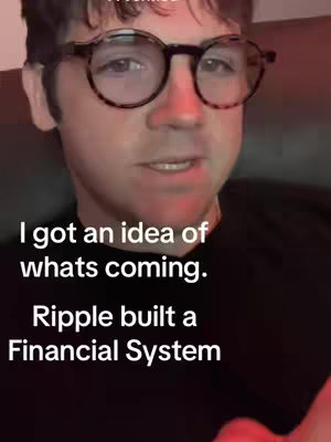 A man with glasses speaks directly to the camera in a well-lit room with text overlayed on the bottom. The colors are warm with the lighting.
