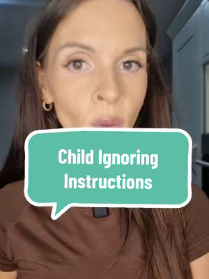 A woman with long brown hair and a brown top is centered in the frame.  Her expression is one of mild concern.  A teal speech bubble overlay with the text "Child Ignoring Instructions" is positioned below her face.