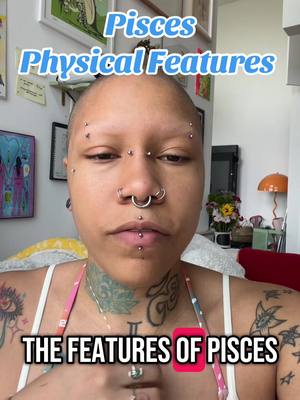 A selfie-style video cover image shows a person with a shaved head, multiple facial piercings, and tattoos on the neck and arms. Text overlays list 'Pisces Physical Features' and 'The Features of Pisces'. The background appears to be an interior space with paintings.