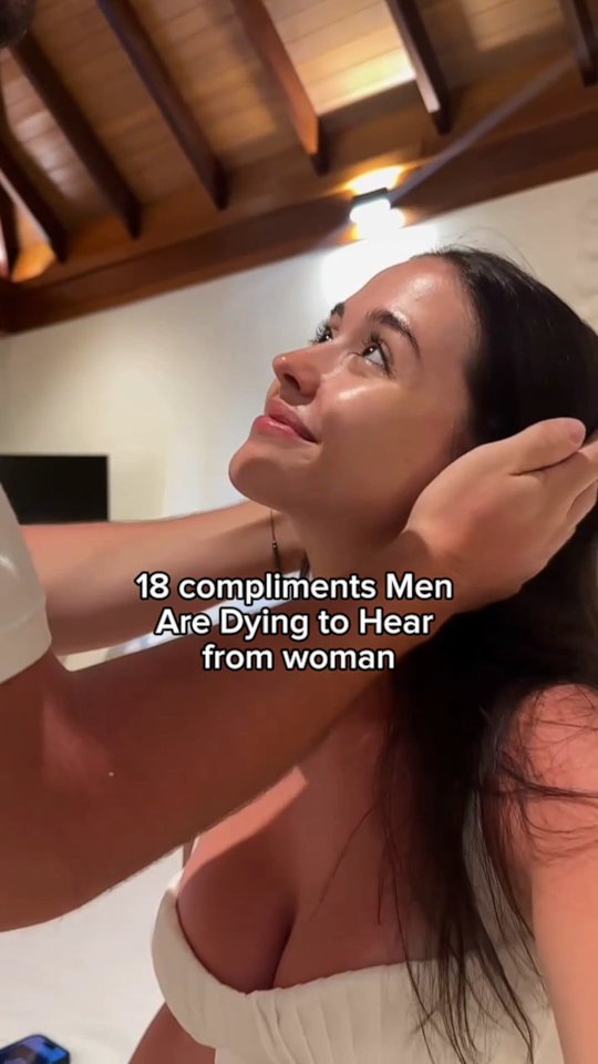 A woman is seen in the middle of the frame, looking upwards, with her head tilted back. The top of a man's arm is visible, appearing to be caressing the woman's hair. Text overlayed at the bottom of the woman's neck reads.
