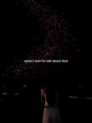 The image is a vertical video thumbnail with a dark background. Against this backdrop, a trail of glowing orange lights ascends diagonally from the lower right towards the top center. At the bottom, a person, presumably the creator, is silhouetted in what appears to be a white dress or top, their arms possibly raised or angled. The overlay text, 'when I start to talk about God', is placed in white at the center.