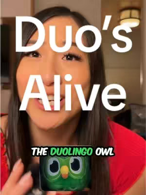 A woman with dark hair is centered in the frame, smiling with her mouth open. Overlayed on the image are large white text and a graphic of the Duolingo owl icon.