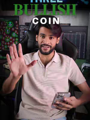 A man sits in a black gaming chair, smiling and gesturing with his right hand toward the viewer. He holds a phone in his left hand, and behind him are computer monitors displaying data. Text overlays are placed at the top.