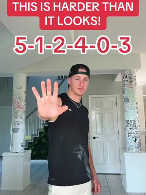 A young man stands in front of a brightly lit interior, holding up his hand with his palm out. Across the top is a red banner with white text, and underneath is a sequence of numbers.