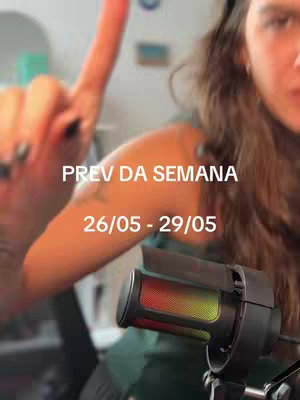 The cover image features a woman with long brown hair, partially visible, holding a microphone. The background is out of focus. Overlaid is text in white, stating "PREV DA SEMANA" above "26/05 - 29/05".