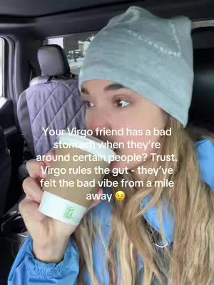 A woman in a light gray beanie and a blue jacket is holding a coffee cup, looking toward the right. Text is overlaid to the bottom left of the image.