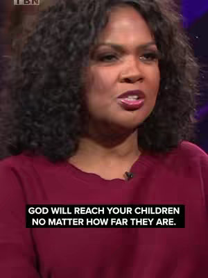 A medium shot features a Black woman looking slightly up and to the right. She wears a dark red top and has curly black hair. White text on a black band at the bottom states, “GOD WILL REACH YOUR CHILDREN NO MATTER HOW FAR THEY ARE.” The background suggests a studio setting.