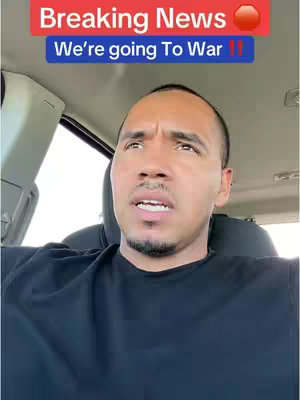 A man is sitting in a car, looking up and to the right, as if in thought. Above his head, there are red and blue text boxes and an emoji is added to the right.