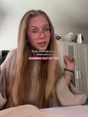 A young woman with long blonde hair and glasses is looking towards the camera. She is sitting at a desk with her hands and arms visible, and there is a notebook visible in front of her. The background includes a white painted dresser and a few visible items that create a homey study environment. The hook text overlayed on the image reads:
Study methods to use
when you're
RUNNING OUT OF TIME