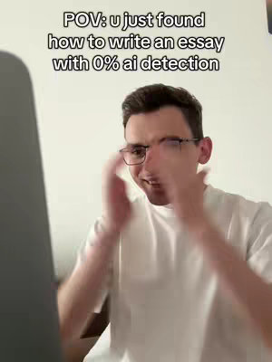 A young man wearing glasses is shown in a medium shot, positioned with his hands raised in an exaggerated, applauding gesture. The background is a blurred, interior setting with hints of white. The man’s expression suggests excitement or surprise. Overlay text in a white box states the video's topic.