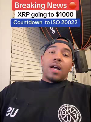 A man in a black shirt with a logo is filming himself in what appears to be a home setting, with overhead lights, and blinds in the background. Overlaying the image are formatted text elements.