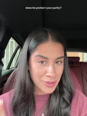 A woman with long, dark hair and light makeup looks at the camera while sitting in a car. The text overlay reads "does he protect your purity?". The background has car seats and a window visible.