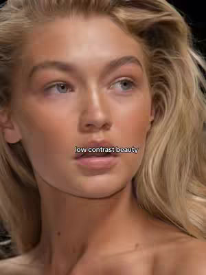 A close-up shot of a fair-skinned woman with blonde hair, a light make-up with a text overlay.