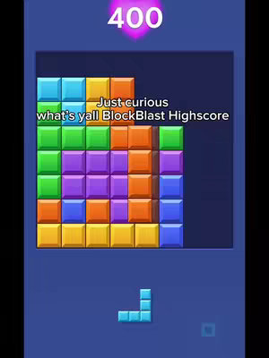 The image shows a mobile game interface. It features a grid of colorful blocks. In the upper left corner, blocks are stacked to form a shape while a separate piece is shown at the bottom. The text overlay asks the viewer to share their high score.