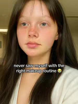 A close-up shot of a young woman with long dark hair and light skin. She is looking slightly to the side with a neutral expression. Text is overlaid on the image.