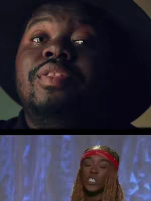 Split screen with the close up of a man's face in the top, looking to the upper left side and in the bottom half, there is a woman wearing a red headband and looking up, singing. The background is not very visible.