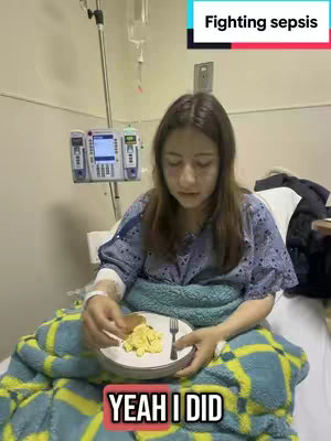 A person, likely a female, is sitting up in a hospital bed, wearing a hospital gown. They are holding a plate with food, likely scrambled eggs and toast, and a fork. Equipment typical to a hospital setting is visible, including an IV drip and a monitoring system. Overlay text indicates a message about fighting sepsis.