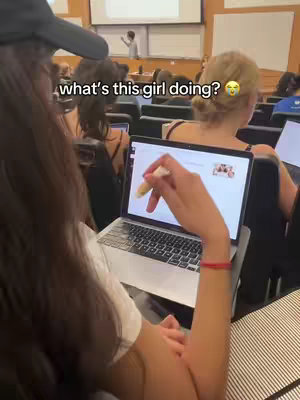 The cover image shows a person working on a laptop in a classroom setting. The focus is on a student working on a laptop in what appears to be a classroom, with the back of another student in focus.