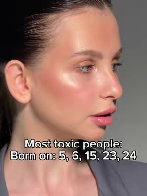 A close-up shot of a woman's face with soft lighting and a blurred grayscale background. The woman has smooth skin, a subtle blush, and lightly glossed lips. Her hair is pulled back, and she gazes off to the side. Text overlays are placed at the bottom of the frame.