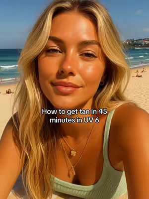 A selfie-style video shows a woman with long blonde hair, a relaxed smile, and a tanned complexion. She wears a light green tank top, and her neck and shoulders are visible. The background shows a beach scene with the ocean, sand, and people in the distance. Text overlay says "How to get tan in 45 minutes in UV 6".