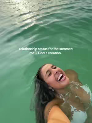 The cover image shows a woman in a body of water, likely a lake or ocean. She is smiling widely with her head above the water, and the background consists of the water surface with ripples and sunlight reflecting off its surface.