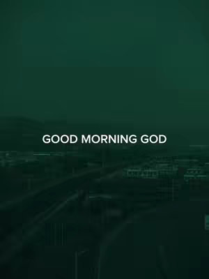 The image is a vertically oriented visual featuring a cityscape set against a dark green gradient backdrop. At the bottom of the image, buildings and infrastructure are faintly visible, suggesting a densely populated area. The text overlay 'GOOD MORNING GOD' is centered at the middle of the image in a white, bold font.