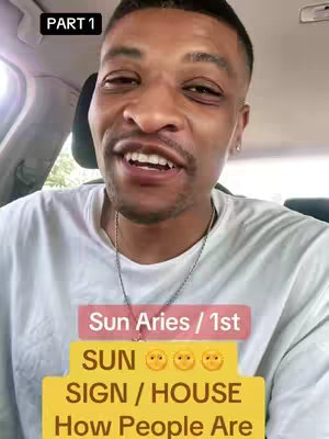 A selfie-style video cover with a man in a white t-shirt speaking earnestly. Overlay text reading, 'PART 1' in the top left and several text boxes are placed beneath. One box reads 'Sun Aries / 1st', a second reads 'SUN 🙄🙄🙄', and a third, in yellow, shows 'SUN SIGN / HOUSE How People Are'. The background is a car interior.