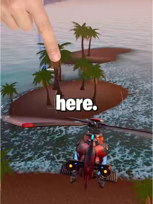 A finger points towards a small island with palm trees; a helicopter is in the foreground. The text overlay says "here." in a bold, white font.