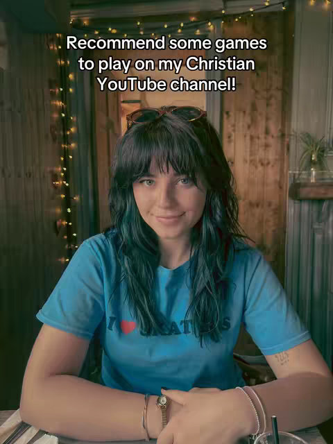 The cover image shows a young woman in a blue t-shirt, looking at the camera with a slight smile. Text overlayed on the image reads, "Recommend some games to play on my Christian YouTube channel!" The background is softly lit with a warm, inviting ambiance, suggestive of an interior setting.