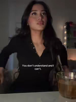 A woman in a dark dress poses looking pensively upwards. Text on the bottom reads: "You don't understand and I can't."