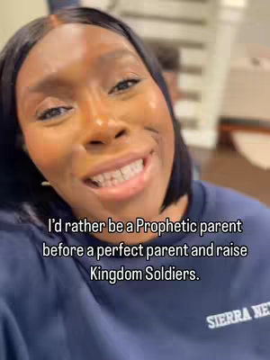Close-up of a woman smiling at the camera. The woman has dark hair and is wearing a dark blue top. Text overlayed on the bottom of the image states, "I'd rather be a Prophetic parent before a perfect parent and raise Kingdom Soldiers."
