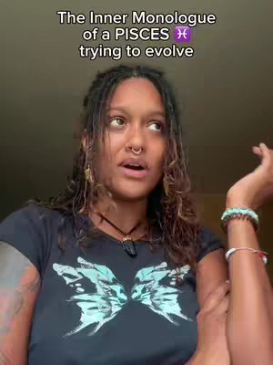 A woman with dark hair and a nose ring looks up and to the side with an open mouth. She is wearing a black shirt with a butterfly design and a necklace. Text at the top of the video reads, 'The Inner Monologue of a PISCES trying to evolve.'