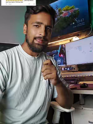 The cover image features a man in a t-shirt seated in front of a computer setup. He is holding a pen, looking toward the camera. A portion of a computer monitor and a larger display with a clock are visible. A small text overlay is in the top left corner.