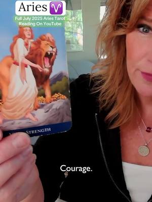 A woman with red-orange hair holds a tarot card featuring an image of a woman holding a lion. The woman is looking at the camera and the text 'Courage' is overlaid on the lower portion of the image.