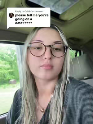 A woman with blonde hair and glasses is looking at the camera while inside of a car with a text bubble that reads "please tell me you're going on a date?????" overlayed on the top left corner.