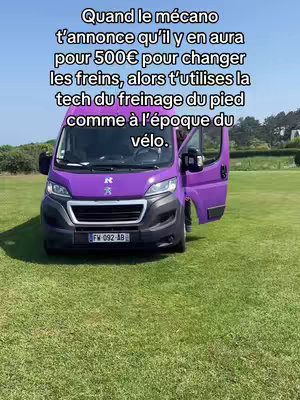 The image shows a purple van parked on a green lawn. Text overlays on the top. The van's door is open. In the background are trees.