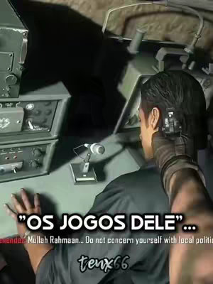 The cover image shows a scene from a video game, with a person's hand holding a gun aiming towards a person who is sitting down in a vehicle. The overlay text in Portuguese reads "OS JOGOS DELE".