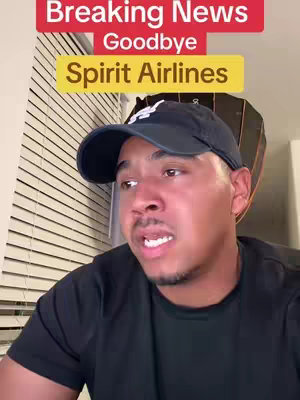 A man wearing a black baseball cap is filmed from the chest up. The background is a wall with window blinds. Above the man's head, a red banner reads "Breaking News," and beneath that, a text overlay in a yellow box says "Goodbye Spirit Airlines."