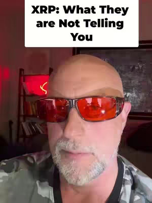 A man with red-tinted glasses looks directly at the viewer. Above him is a white rectangle with black text.