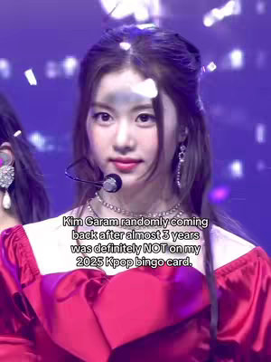 The cover image shows a young woman with dark hair and a concerned expression, set against a blurred background, likely on a stage. She wears a red dress and a microphone is positioned near her mouth.