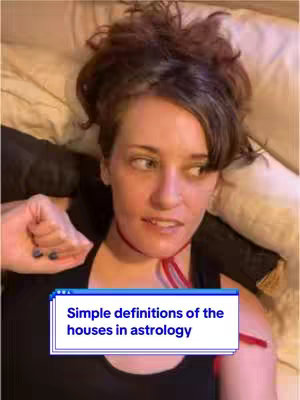 A woman is lying in bed, looking up and slightly to the side with a questioning expression. She has short, dark hair and is wearing a black top. A red cord is around her neck. An overlay at the bottom features a computer window design with blue borders and the text "Simple definitions of the houses in astrology".