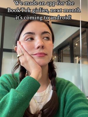 A young woman with brown hair in pigtails looks to the side, resting her hand on her cheek. She wears a green sweater and gold jewelry. Overlay text at the top states the app is for BookTok girlies, launching to Android devices next month, hinting at the app's release.