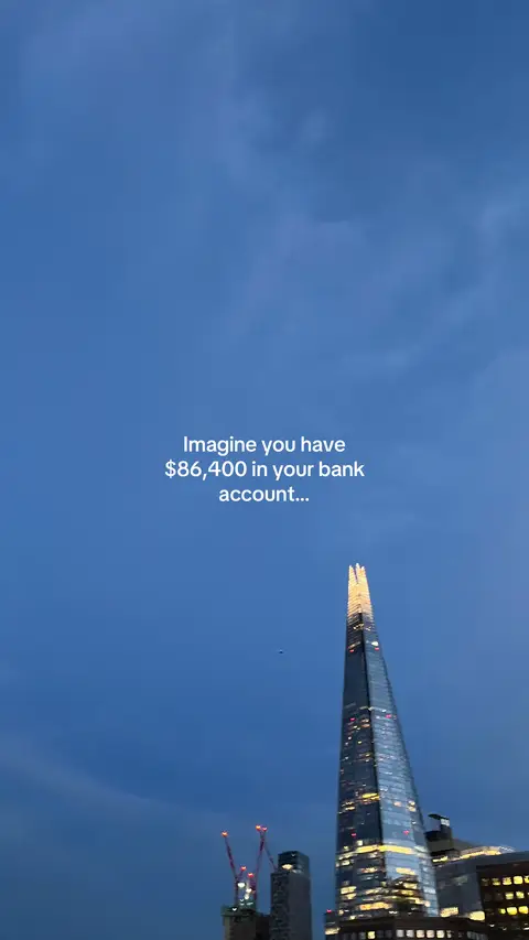 A vertical shot of a blue sky with clouds. In the foreground, there's a tall skyscraper illuminated with lights at the top. Text overlayed in the middle says: 'Imagine you have $86,400 in your bank account...'