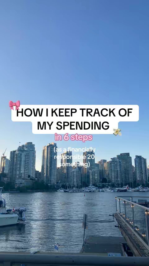 The cover image shows a cityscape with tall buildings under a partly cloudy sky. In the foreground is a body of water with a dock and boats. Overlaid on the image is a text box with the title "HOW I KEEP TRACK OF MY SPENDING in 6 steps" and additional text indicating the content is for a "financially responsible 20 something". Decorative elements like a bow and money symbols are included.