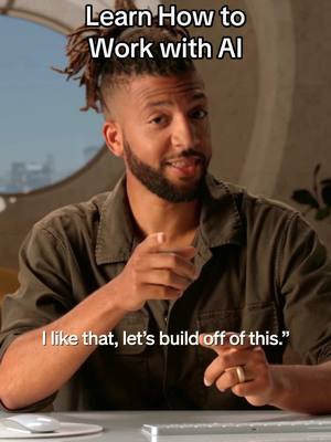 A man with locs is pointing towards the viewer with his right hand. He is wearing a green shirt and has text overlayed on the top left of the image that says "Learn How to Work with AI".