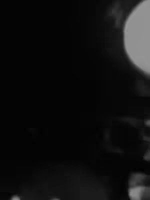 The cover image appears blurred and predominantly black, suggesting a nighttime or low-light setting. There is a circular, bright feature in the top right corner, possibly a light source.
