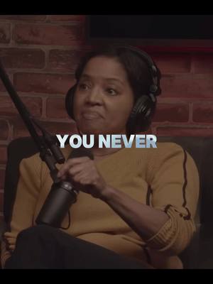 A woman with dark hair wearing headphones and a yellow sweater is shown, with a microphone in front of her. The image has the text 'YOU NEVER' overlaid in a metallic font.