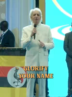 The cover image shows a man speaking into a microphone on a stage. He is wearing a white suit. Behind him is a blue screen and a flag with a bird on it.. Text overlayed on the bottom reads, "GLORIFY YOUR NAME."