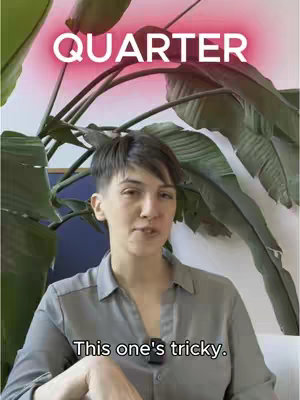 The image shows a woman speaking in front of a backdrop of large green leaves, with text overlays at the top and bottom. The top text is in large, white letters on a vibrant pink background, reading 'QUARTER.' The woman, with short hair and a grey button-up shirt, appears to be addressing the viewer. Below her, smaller text says, 'This one's tricky.' The composition is well-lit and focuses on the woman, making her the center of attention against the natural, leafy backdrop.