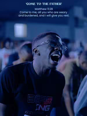 The cover image shows a man with short hair, wearing glasses and a black t-shirt. He is mid-scream, mouth wide open, displaying his teeth, seemingly in a moment of intense emotion. Text overlayed in the upper part of the image quotes Matthew 11:28, with the title 'COME TO THE FATHER.' The man appears to be in a public setting, with blurred figures in the background, suggesting a performance or gathering. The lighting is somewhat dark with the use of blue tones.